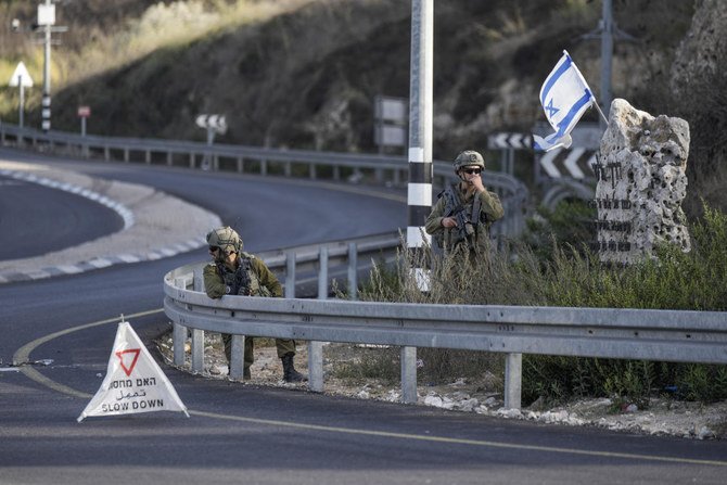 Israeli soldiers take position at a roadblock near the West Bank town of Nablus, on Saturday. (AP)