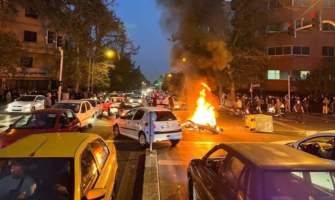 A police motorcycle burns during a protest over the death of Mahsa Amini, Tehran, Iran, Sept. 19, 2022. (Reuters)