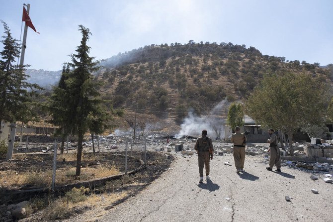 Members of exiled Komala Party inspect aftermath of bombing in the village of Zrgoiz, near Sulaimaniyah, Iraq, where the bases of several Iranian opposition groups are located, Wednesday, Sept. 28, 2022. (AP)