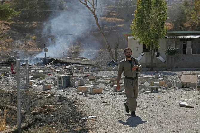 A Kurdish peshmerga fighter inspects the damage following an Iranian cross-border attack in the area of Zargwez, where several exiled left-wing Iranian Kurdish parties maintain offices. (File/AFP)