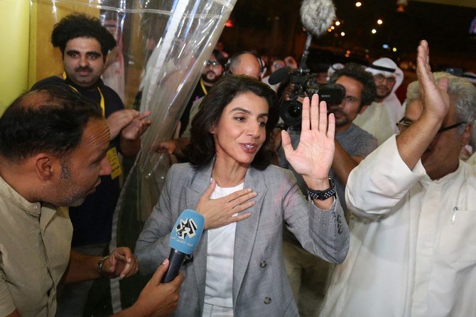 Alia Al-Khaled, center, celebrates with her supporters following the announcement of her victory in Kuwait’s parliamentary elections early on Sept. 30, 2022. (AFP)