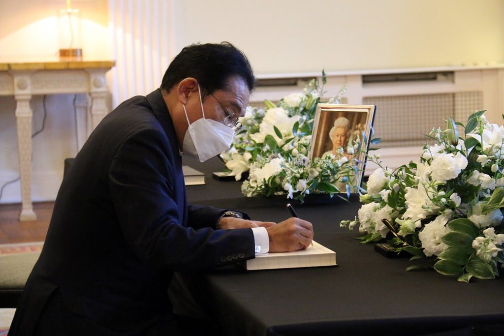 The Japanese prime minister signing a book of condolences at the British Embassy in Tokyo. (Twitter/@UkinJapan)