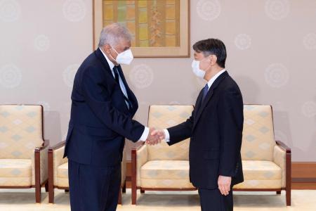 This handout picture taken and released on September 28, 2022 and provided by the Imperial Household Agency of Japan shows Sri Lanka's President Ranil Wickremesinghe (left) shaking hands with Japan's Emperor Naruhito during their meeting at the Imperial Palace in Tokyo. (AFP)
