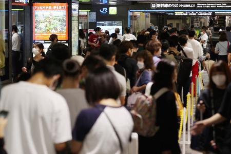 Passengers gather as train service is suspended due to Typhoon Nanmadol approaching Kyushu region, at Hakata station of Fukuoka on September 18, 2022. (Photo by JIJI PRESS / AFP)