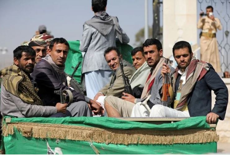 Armed Houthi followers riding on the back of a truck participating in a funeral of Houthi fighters. (Reuters/File Photo)