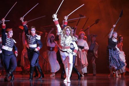 In this file picture taken on Feburary 17, 2006, Kei Aran (centre) performs as Oscar Francois de Jarjayes, a female captain of the royal guards of French Queen Marie-Antoinette, during the Takarazuka theatre's