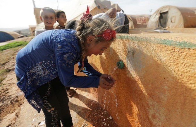 An internally displaced Syrian girl drinks water at Teh camp in northern Idlib, Syria May 5, 2021. (Reuters)