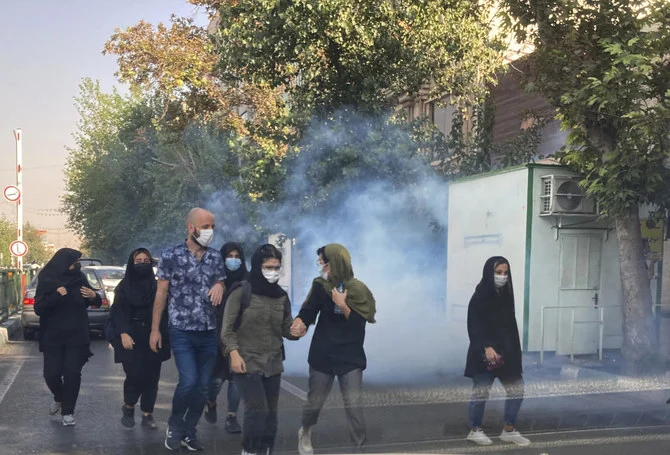 Tear gas is fired by security to disperse protestors in front of the Tehran University, Iran. (File/AP)
