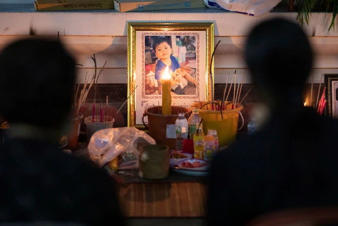 Relatives of victims of a mass killing attack attend a memorial in Uthai Sawan, northeastern Thailand, Sunday, Oct. 9, 2022. (AP)