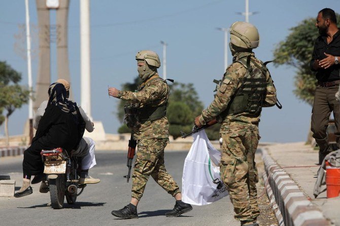 Turkish-backed Syrian fighters patrol the rebel-controlled town of Tal Abyad in Syria’s northern Raqqa province, on October 6, 2022. (AFP)