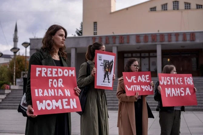 Women take part in a rally in support of Iranian women in Pristina on Wednesday. A wave of unrest has rocked Iran since 22-year-old Masha Amini died on September 16 after her arrest by the morality police in Tehran. (AFP)
