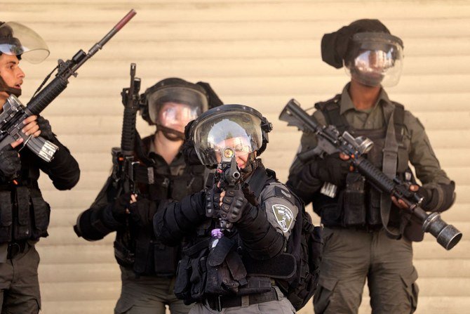 Israeli security forces take positon amid clashes with Palestinians as Israeli settlers visit the tomb of Othniel Ben Kenaz during the Jewish religious holiday of Sukkot, in the flashpoint city of Hebron in the occupied West Bank on October 12, 2022. (AFP)