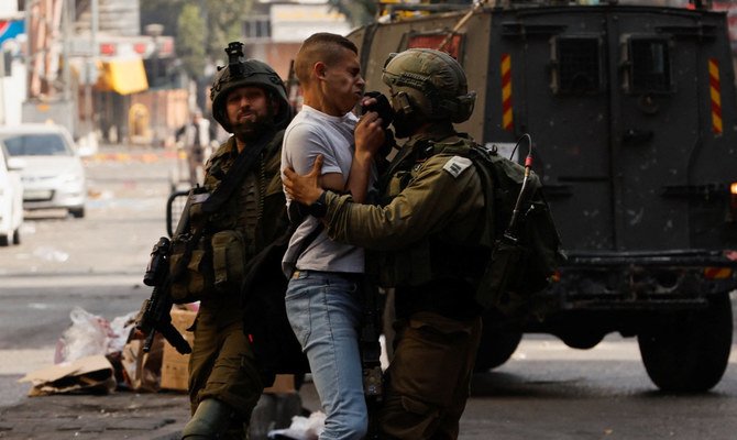 A Palestinian man clashes with Israeli forces in Hebron, in the Israeli-occupied West Bank October 12, 2022. (Reuters)