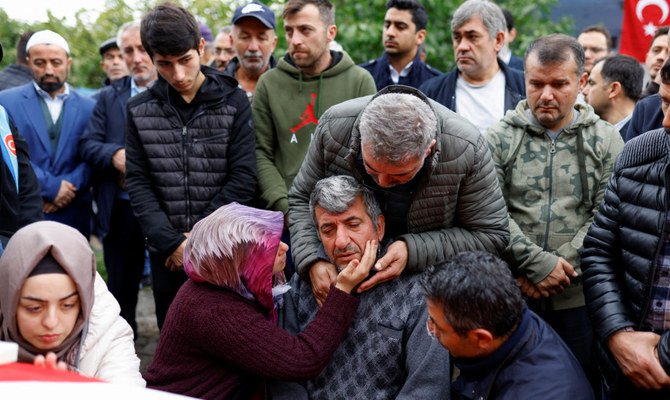 Mourners react during a funeral ceremony of the mine blast victims in the village of Ahatlar in the northern Bartin province, Turkey. (Reuters)