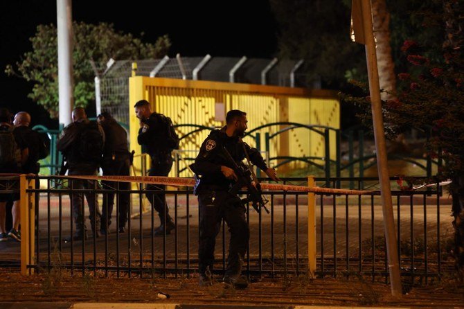 Israeli soldiers stand over a body following a reported attack at the entrance of the Israeli settlement of Maale Adumim in the occupied West Bank on Jerusalem's outskirts on Wednesday. (AFP)