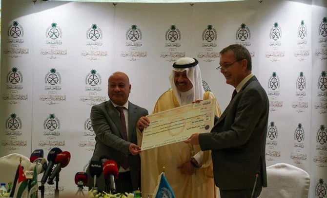 Saudi ambassador to Jordan Nayef Al-Sudairi, UNRWA’s Under-Secretary-General, Philippe Lazzarini and Dr. Ahmad Abu Holie, member of the Executive Committee of the Palestine Liberation Organization sign MoU in Amman. (Abdulrahman Shalhoub/ Arab News)