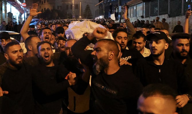 Men carry Hamdi Sharaf's body after clashing with Israeli forces in Nablus, in the occupied West Bank on early October 25, 2022. (AFP)