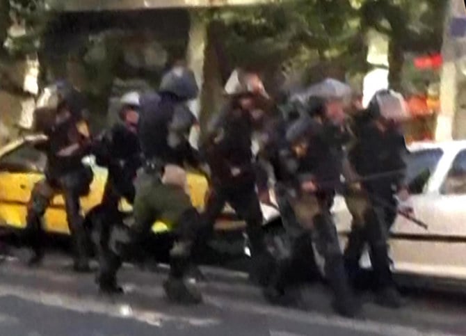 Iranian riot police can be seen in this screenshot before confronting protesters the capital in Tehran. (AFP)