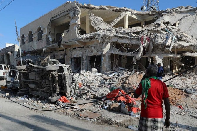 A local residents looks at debris from a destroyed buildings in Mogadishu on October 30, 2022 after an car bombing targeted the education ministry on October 29, 2022. (Reuters)