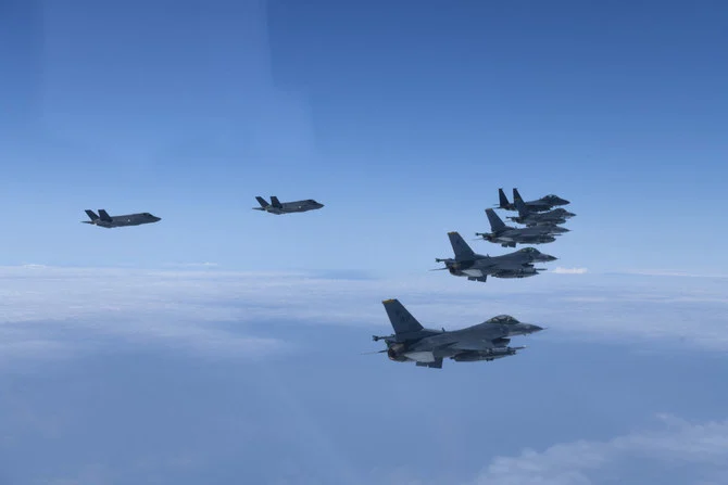 South Korean warplanes, including F-35 stealth fighters, and US F-16 jets flying in tactical formation in airspace over South Korea, in response to North Korea's missile tests on June 7, 2022. (AFP/Pool)