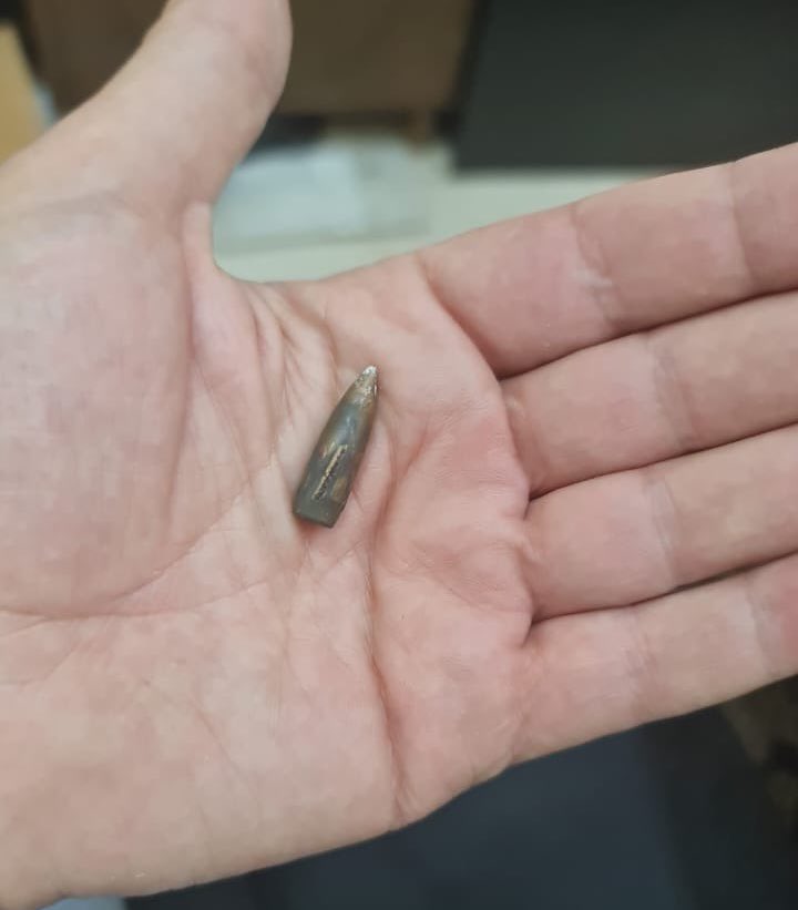 Japanese ambassador to Lebanon Takeshi Okubo holds a stray bullet that landed in his residence in Baabda, Lebanon. (Twitter)