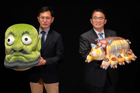 Japanese film director Goro Miyazaki (left) and Aichi Prefectural Governor Hideaki Omura (right) pose for photographs during a press conference at the new Ghibli Park in Nagakute, Aichi prefecture on October 12, 2022. (AFP)