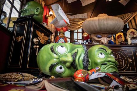 A member of staff (left) cleans a window of an exhibit at Ghibli's Grand Warehouse during a media tour of the new Ghibli Park in Nagakute, Aichi prefecture on October 12, 2022. (AFP)