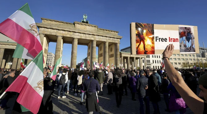 People gather in front of the Brandenburg Gate in Berlin, Germany, Friday, Oct. 7, 2022 to protest against the government in Iran in memory of Mahsa Amini. (AP)
