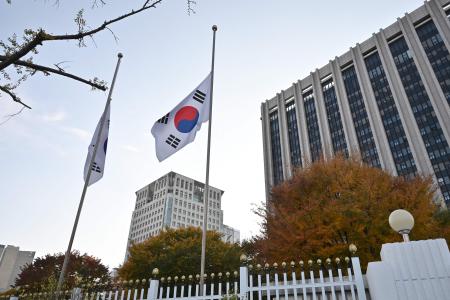 South Korean national flags flutter at half-mast at the government complex in Seoul on October 30, 2022, after the Halloween stampede in the capital's popular Itaewon district. (AFP)