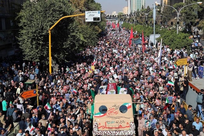 Mourners gathered Saturday in the southern Iranian city of Shiraz to bury the victims of a deadly assault on a shrine. (INA/AFP)