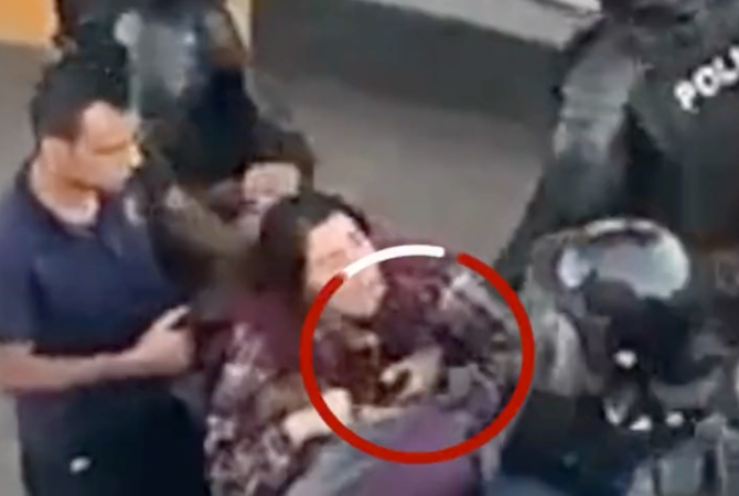 The video shows a policeman assaulting a woman. (Videograb/BBC Persian)
