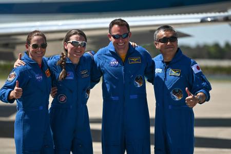 From left: US astronaut Nicole Mann, Russian cosmonaut Anna Kikina, US astronaut Josh Cassada and Japanese astronaut Koichi Wakata pose for pictures at the Kennedy Space Center, Florida, on October 1, 2022, ahead of the October 5 launch of a SpaceX Falcon 9 rocket that will launch a Crew Dragon spacecraft on its eighth flight with astronauts. (AFP)