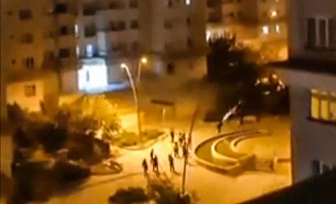 This grab from a UGC video posted on Thursday shows what appears to be Iranian security forces firing projectiles in a housing estate in Tehran. Cities across Iran have seen protests since Mahsa Amini’s death in September. (AFP)