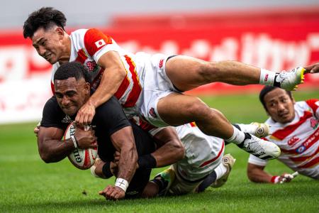 New Zealand's Sevu Reece is tackled by Japan's Ryoto Nakamura during the rugby union Test match between Japan and New Zealand’s All Blacks at the National Stadium in Tokyo on October 29, 2022. (AFP)