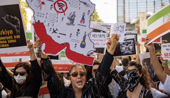 Protestors hold banners as they take part in a rally outside the Iranian consulate in Istanbul on September 29, 2022. (AFP)