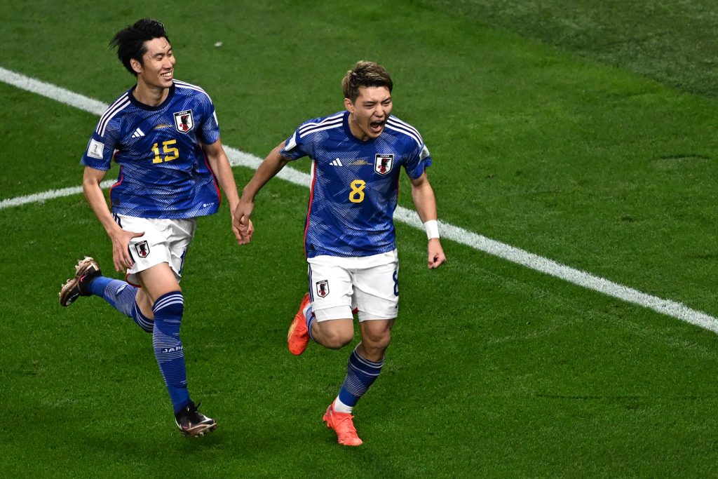 Japan's midfielder Ritsu Doan (right) celebrates scoring his team's first goal during the Qatar 2022 World Cup Group E football match between Germany and Japan at the Khalifa International Stadium in Doha on November 23, 2022. (AFP)