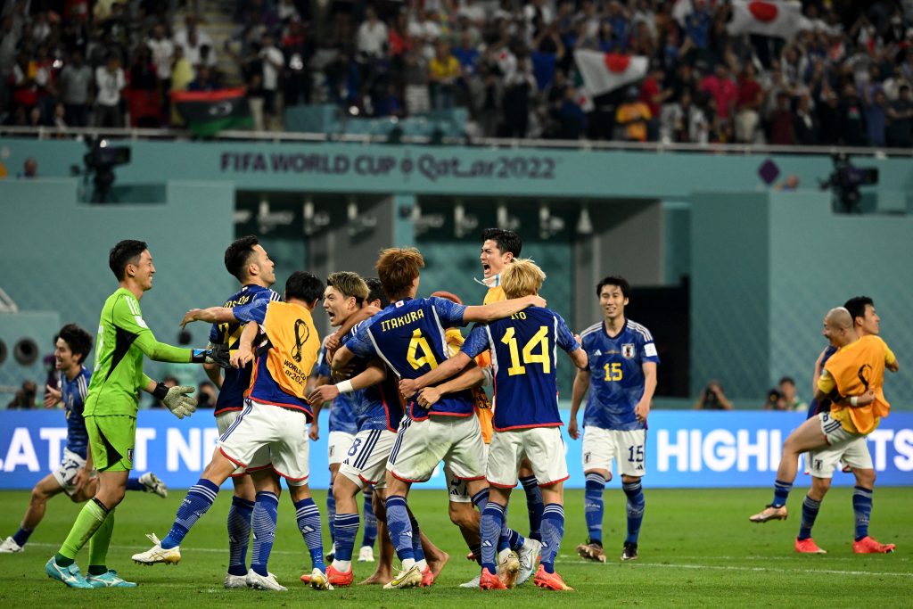 Japan's players celebrate after defeating Germany 2-1 in the Qatar 2022 World Cup Group E football match between Germany and Japan at the Khalifa International Stadium in Doha on November 23, 2022. (AFP)