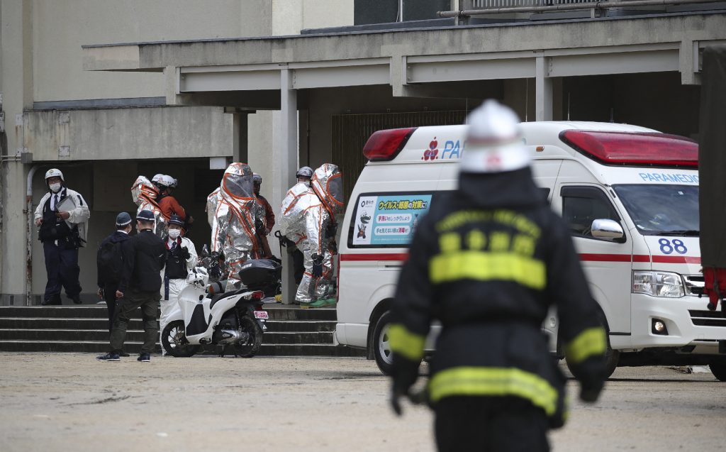 Rescue workers gather in front of an elementary school where children complained of poor physical condition due to a strange odor in Toyonaka, Osaka prefecture on November 29, 2022. (AFP)