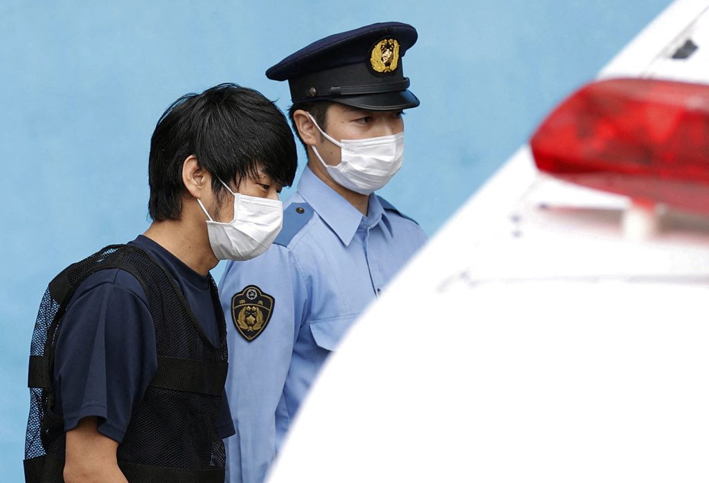 Tetsuya Yamagami, suspected of killing former Japanese premier Shinzo Abe, is escorted by a police officer as he is taken to prosecutors, at Nara-nishi police station in Nara, western Japan, July 10, 2022. (File/Kyodo via Reuters)