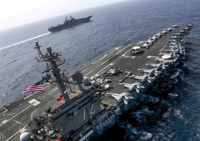 USS Abraham Lincoln and USS Kearsarge sail alongside in the US 5th Fleet area of operations in the Arabian Sea. (File/AFP)