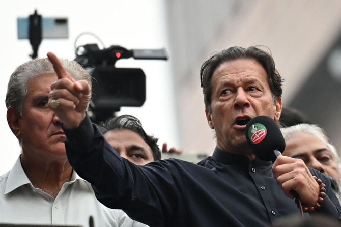 Pakistan’s former prime minister Imran Khan, right, was shot in the foot at a political rally on Thursday. (AFP)
