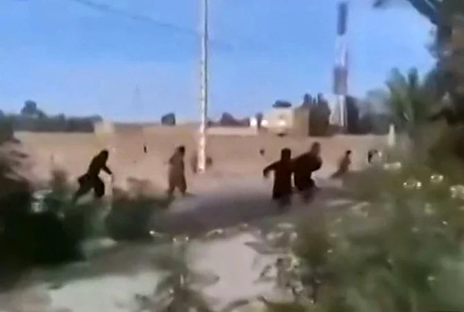 This image grab from a UGC video posted on November 4, 2022, reportedly shows children fleeing from security forces in the city of Khash, in Iran’s Sistan-Baluchistan province. (AFP)