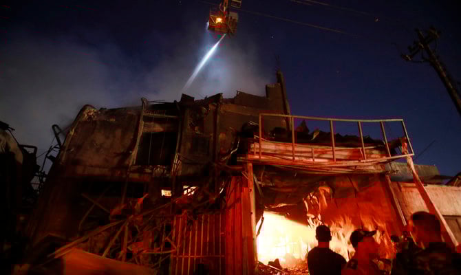 Firefighters work the scene of a fire at a building in Baghdad, Iraq, Sunday, Nov. 6, 2022. (AP)