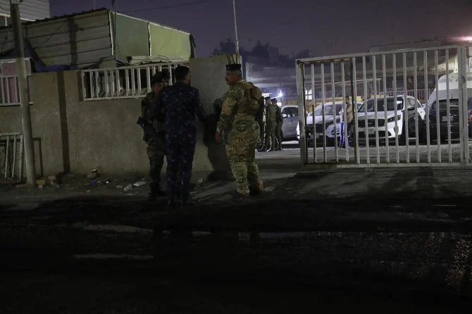 Iraqi security forces gather outside a morgue of Sheikh Zayed Hospital in Baghdad on Monday after assailants shot dead an American aid worker in a rare killing of a foreigner in the Iraqi capital in recent years. (AP)