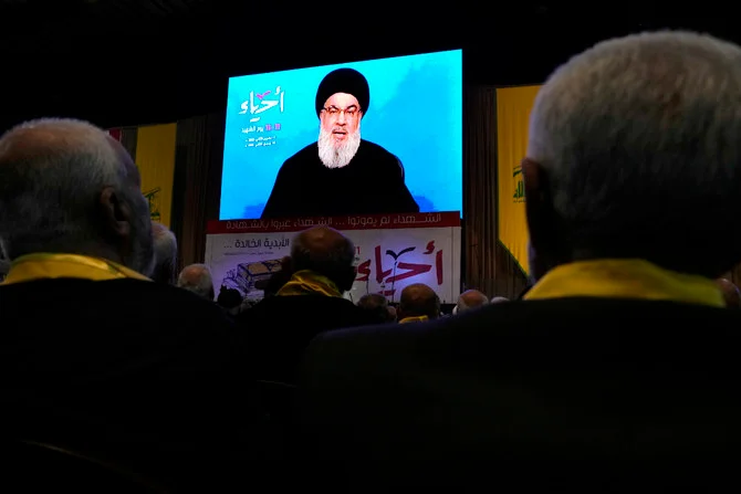 Hezbollah supporters display pictures of relatives who died in fighting as they listen to a speech of Hezbollah leader Sayyed Hassan Nasrallah during a rally on Nov. 11, 2022. (AP)