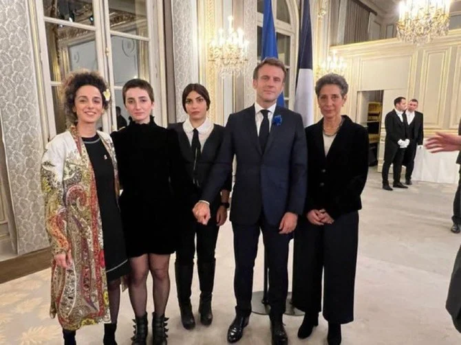 French President Emmanuel Macros is shown with Iranian dissidents in Paris in this picture posted on social media. (Twitter: @Sima_Sabet)
