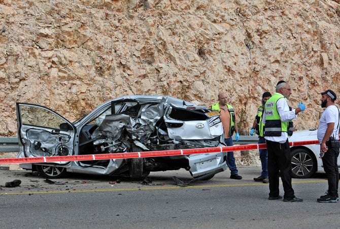 Israeli forensic check the scene of an attack in the Ariel Industrial Zone in the occupied West Bank on Tuesday following an attack in which a Palestinian killed two Israelis. (AFP)