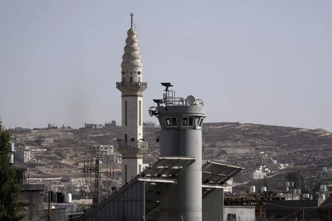 An Israeli military guard tower with two robotic guns and surveillance cameras at the Aroub refugee camp in the West Bank, Thursday, Oct. 6, 2022. (AP Photo/Mahmoud Illean)
