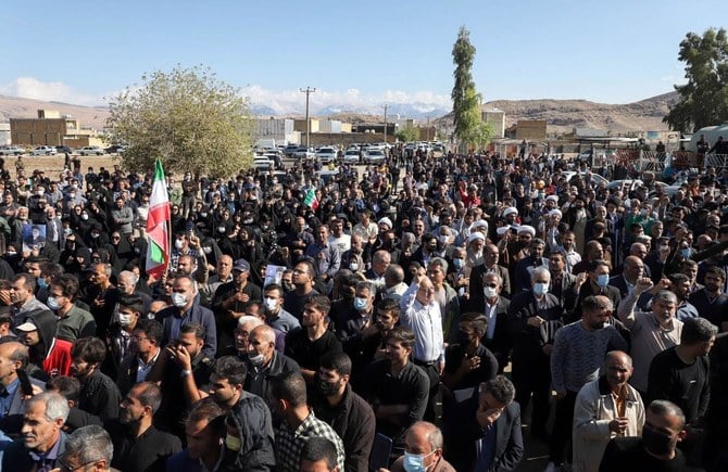 Iranians in the funeral procession of people killed in a shooting attack, in the city of Izeh in Iran's Khuzestan province, on November 18, 2022. (AFP)