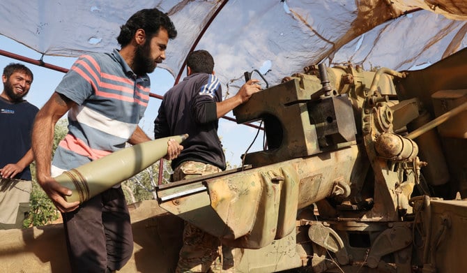 Syrian opposition fighters fire artillery at pro-government forces from a position in the northwestern Idlib province, on November 6, 2022. (AFP)